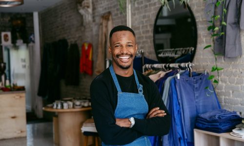 a-man-in-denim-apron-smiles-for-the-camera-min