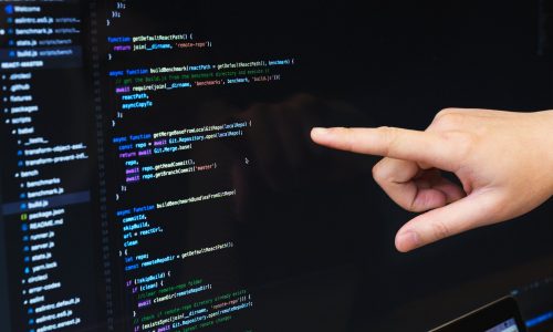 finger-pointing-at-javascript-code-min