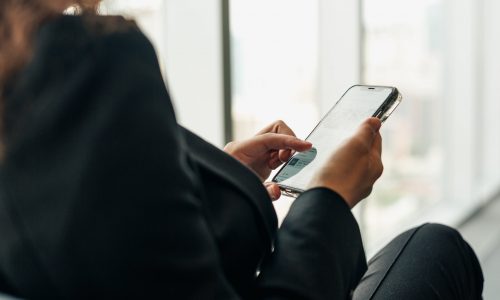 woman-holding-phone-browsing-social-media-min